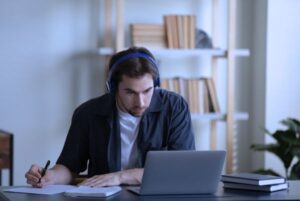 Persona estudiando con auriculares frente a un portátil, ejemplo de uso del modo concentración digital para evitar distracciones estudio.